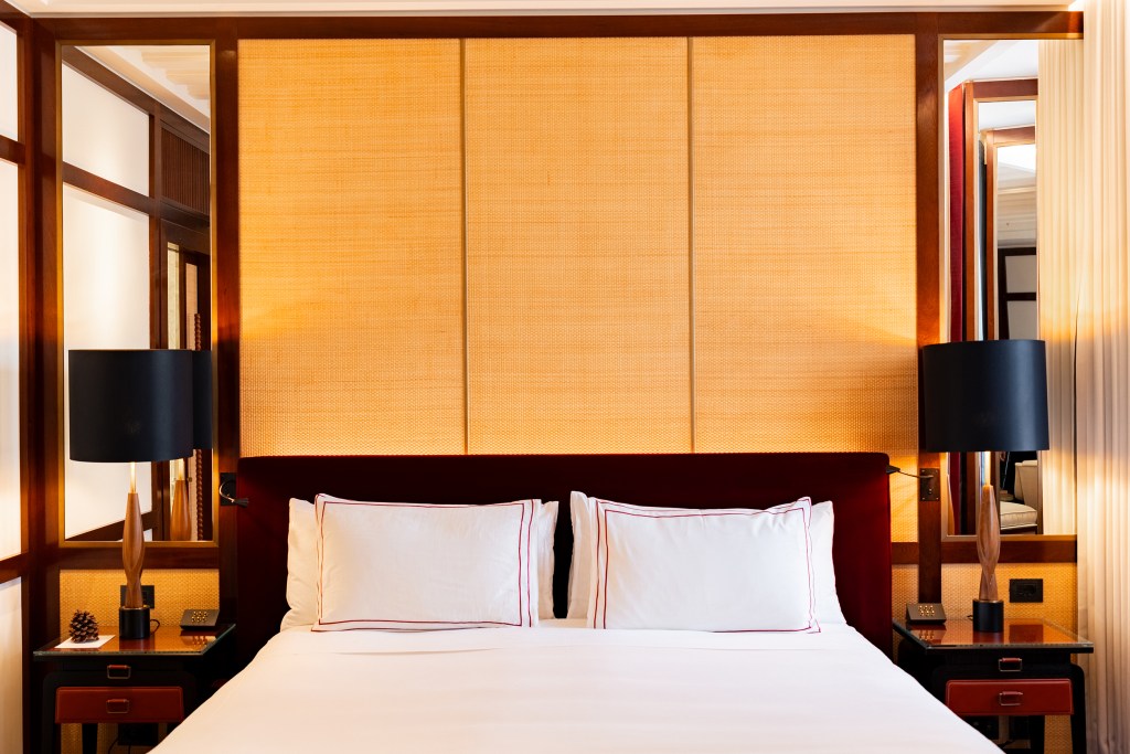 Horizontally framed guest room at Portrait Hotel Milano featuring a plush bed and bedside lamps