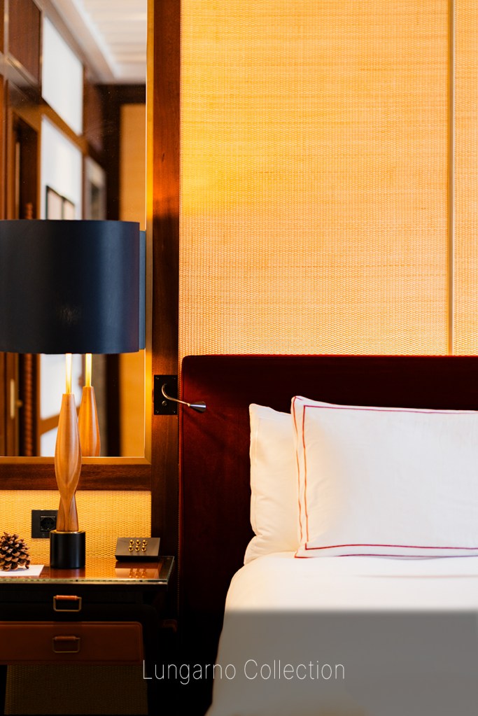 Portrait-oriented view of Portrait Hotel Milano guest room with luxurious headboard and ambient lighting