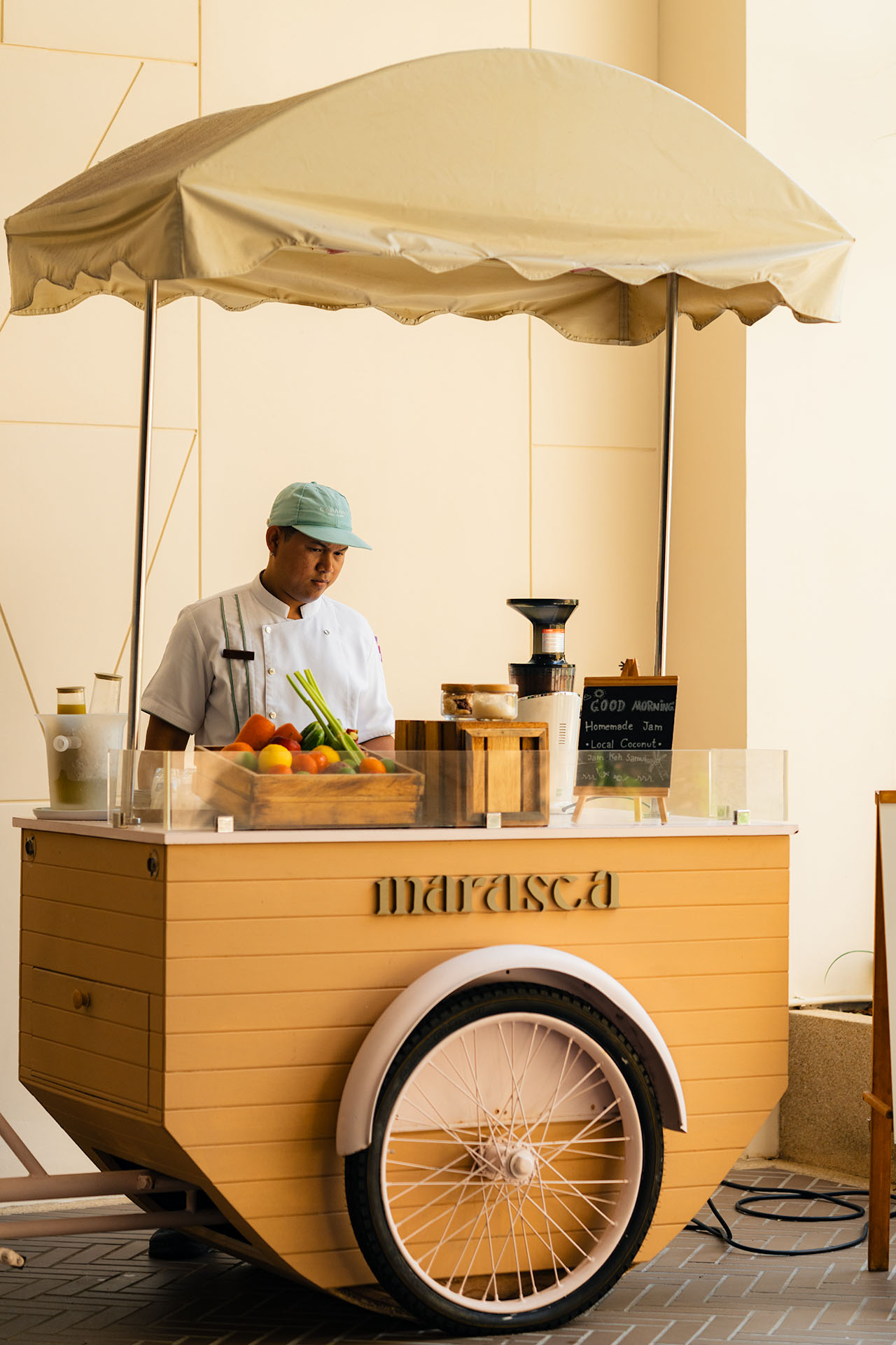 Chef preparing fresh juice at Marasca Koh Samui's signature morning cart with local fruits and cold-press juicer — Small Luxury Hotels